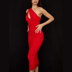 a woman in a red dress posing for the camera with her hands on her hips