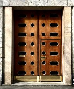 a large wooden door with holes in it