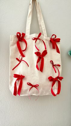 a tote bag with red ribbon tied around it