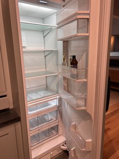 an open refrigerator with the door ajar and no ice maker on it's side