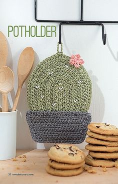 a crocheted cactus purse next to cookies and utensils