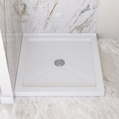 a white shower stall with marble walls and floor