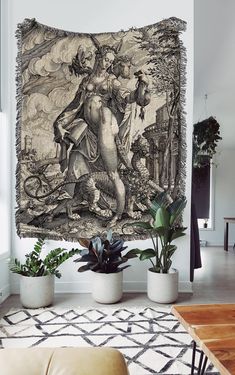 a tapestry hanging on the wall in a living room with plants and potted plants