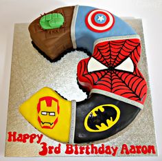 the birthday cake is decorated with superheros and spider - man