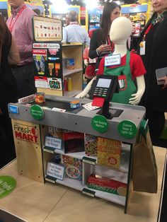 a store display with a mannequin wearing an apron and holding a cell phone