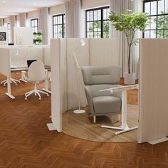 an office cubicle with chairs, desks and plants in the middle of it