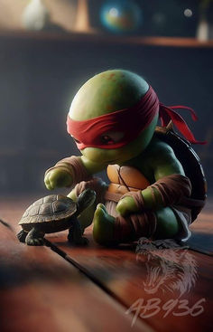 a little turtle sitting on top of a wooden table next to a small turtle wearing a red bandana