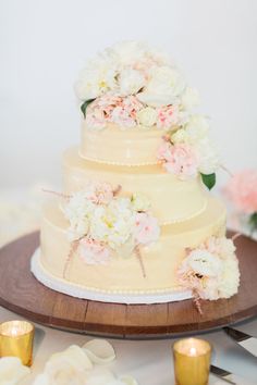 a wedding cake with white and pink flowers on it