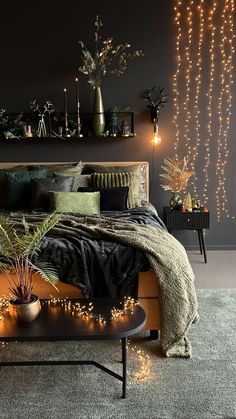 a bedroom with lights and plants on the wall