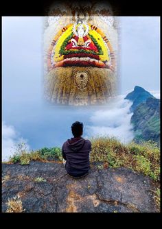 a man sitting on top of a rock next to a painting with the image of buddha