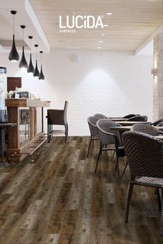 an image of a restaurant setting with wood flooring and chairs in the dining area