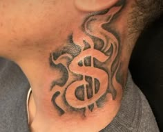 a man with a tattoo on his neck has a dollar sign tattooed on it's chest