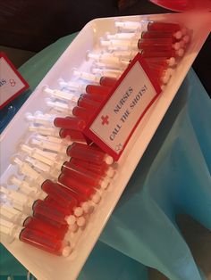 a tray filled with red and white toothpicks on top of a table