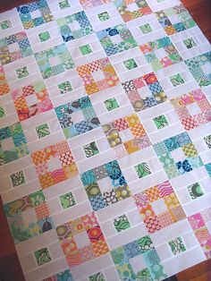 a quilted table top with colorful squares on it