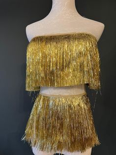 a mannequin with gold fringe on it