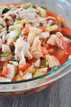 a glass bowl filled with pasta and vegetables