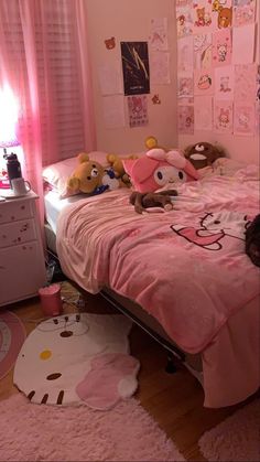 there is a bed with pink sheets and stuffed animals on it