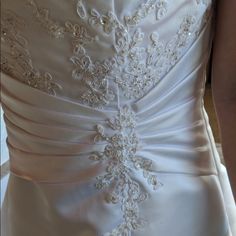 the back of a wedding dress with beading on it