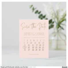 save the date card with gold foil lettering on pink paper and white flowers in vase