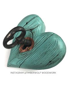 two heart shaped wooden boxes with black handles