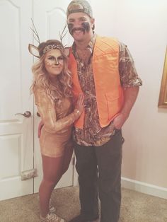 a man and woman are dressed up as deer antlers for the halloween costume contest