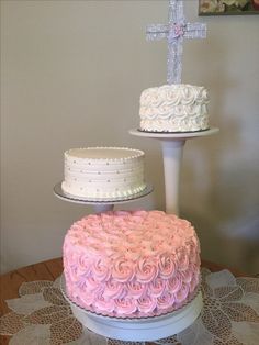 three tiered cakes with pink and white frosting