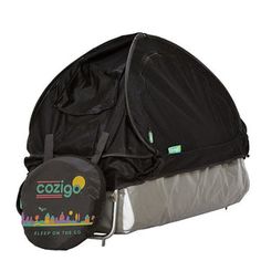 a black bag with the word cozigo on it sitting next to a sleeping bag