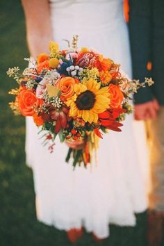 the bride and groom are holding their bouquets