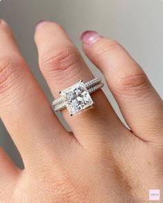 a woman's hand with a ring on it and a diamond in the middle