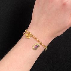 This 14k gold charm bracelet features 8 gemstone and enamel charms -- most were originally antique stickpins (circa 1910). Two of the charms are 10k gold, but the others are all 14k. The bracelet measures 7 inches long and weighs 7.9 grams. It is in good condition with some loss to the enamel on two of the flower charms and some replacement pearls on the opal charm. Materials: 14k gold, Enamel, Gemstones. Yellow Gold Charm Bracelet Fine Jewelry, Fine Jewelry Yellow Gold Charm Bracelet, Yellow Gold Fine Jewelry Charm Bracelet, Yellow Gold Charm Bracelet With Dangling Charms, 14k Yellow Gold Charm Bracelet With Dangling Charms, Yellow Gold Charm Bracelet With Vintage Charm As Gift, Vintage Charm Yellow Gold Bracelet, Vintage Yellow Gold Charm Bracelet Gift, Heirloom Yellow Gold Jewelry With Dangling Charms