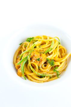 a white bowl filled with pasta and shrimp