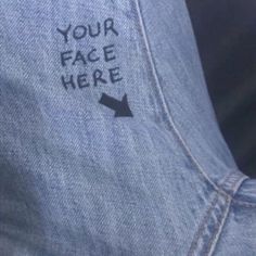 the back of someone's jean jacket with an arrow on it that says your face here