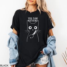 Looking for the perfect funny Halloween cat shirt? Our custom tees are super soft, comfortable to wear, and fit like a well-loved favorite. All orders ship within 1-3 business days and are backed by our Love It Guarantee. ✅ SHIRT FEATURES - Super Soft Feel - Crisp Graphic Print - Custom Design - True Fit Wear - Eco-Friendly Process - Love it Guarantee 📦 PROCESSING & SHIPPING All apparel ships within 1-3 business days and takes another 2-5 days in transit. Your custom shirt will be there before Funny Tshirts For Women Graphic Tees, Fall Cotton T-shirt With Cat Design, Halloween Cat Print Graphic Tee, Cat Mom Shirt, Black Halloween T-shirt With Cat Design, Cute Black Cat, Halloween White T-shirt With Cat Print, Cat Mom Shirts, Halloween Cat Print Crew Neck T-shirt