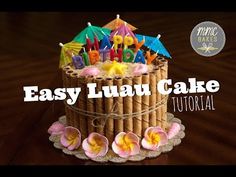 a birthday cake with candles and flowers on the top that says easy luau cake