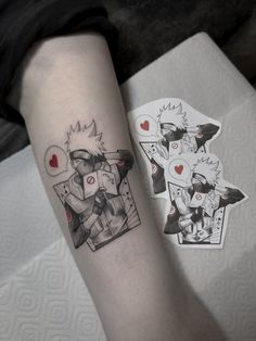 a person with a tattoo on their arm next to some stickers and a piece of paper