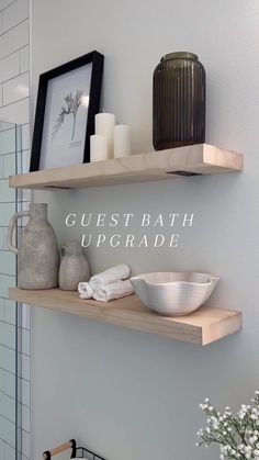 two wooden shelves with towels and vases on them, one shelf has a white bowl in it