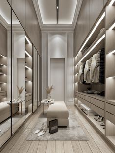 a large walk in closet with lots of clothes on the shelves and shoes on the floor