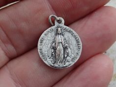 Religious antique French catholic silvered medal pendant Holy charm medallion of Saint Maria Goretti and Holy Virgin Mary. Measures are 0,64 x 0,77 inches ( 1,62 x 1,96 cm ) I bought this beautiful antique locket shrine on a brocante ( fleamarket ) in France. I deliver all over the world. If you want more photos or information, you can contact me. If you don't have paypal, you can pay by bank transfer. Registered shipping is possible. Please take a look at my other items for sale. Silver Miraculous Medal Pendant, Silver Pendant With Miraculous Medal, Saint Maria Goretti, St Maria Goretti, Maria Goretti, St Maria, Antique Locket, Our Lady Of Sorrows, Catholic Medals