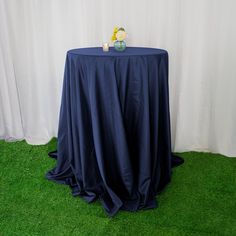 a black table topped with a vase filled with flowers