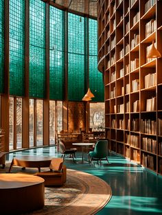 a library with lots of bookshelves and chairs in the center, surrounded by glass windows