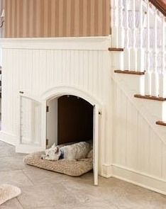 a dog laying on the floor in front of a fireplace