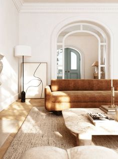 a living room filled with furniture and a fire place next to a doorway in the wall