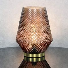 a glass vase sitting on top of a table