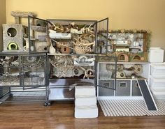 a room filled with lots of different types of bird houses and cages on top of each other