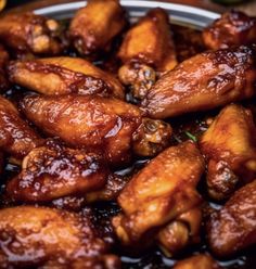 chicken wings with sauce in a bowl on a table