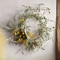 a dried wreath is hanging on the wall