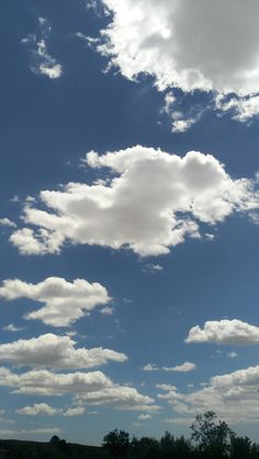 the sky is full of clouds and trees