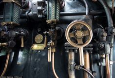 the inside of an old steam engine with many different valves and gauges on it