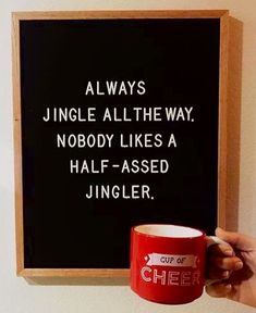 a person holding a red coffee mug in front of a chalkboard with the words, always jungle all the way nobody likes a half - assed juggler