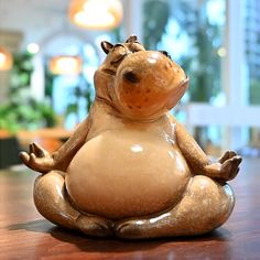 a ceramic figurine sitting on top of a wooden table